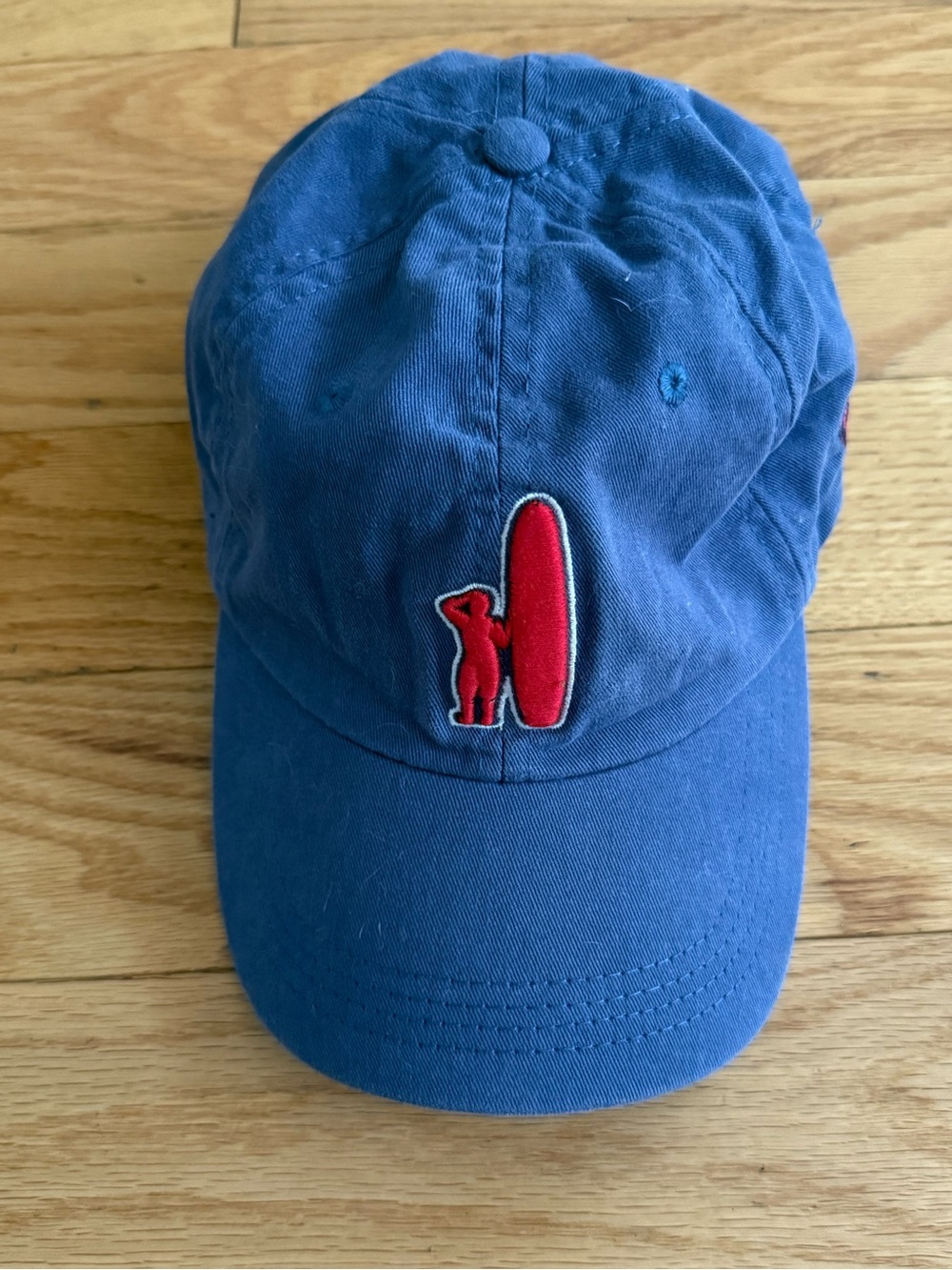 johnnie-O baseball blue cap featuring a red embroidered surfer logo on the front